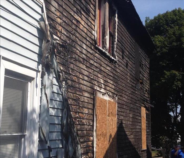 A side of a Scranton home damaged by a fire. The siding was burned off.